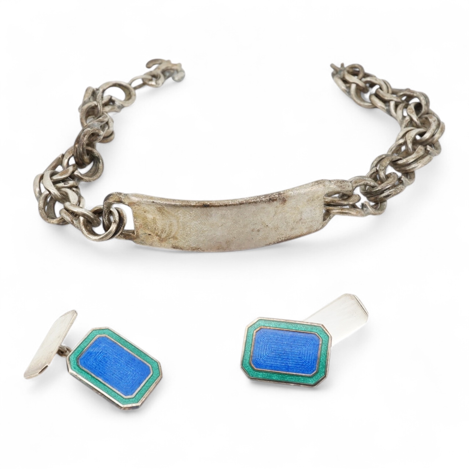 A 1970's silver identity bracelet and a modern pair of silver and two colour enamel cufflinks.